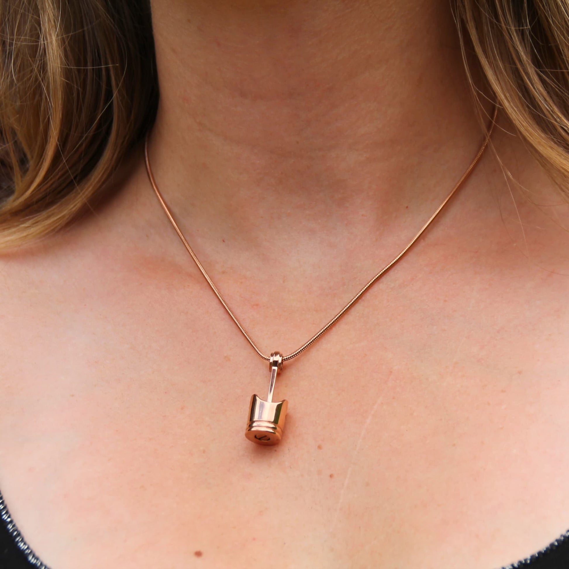 Collier piston rose gold en acier sur chaine fine.