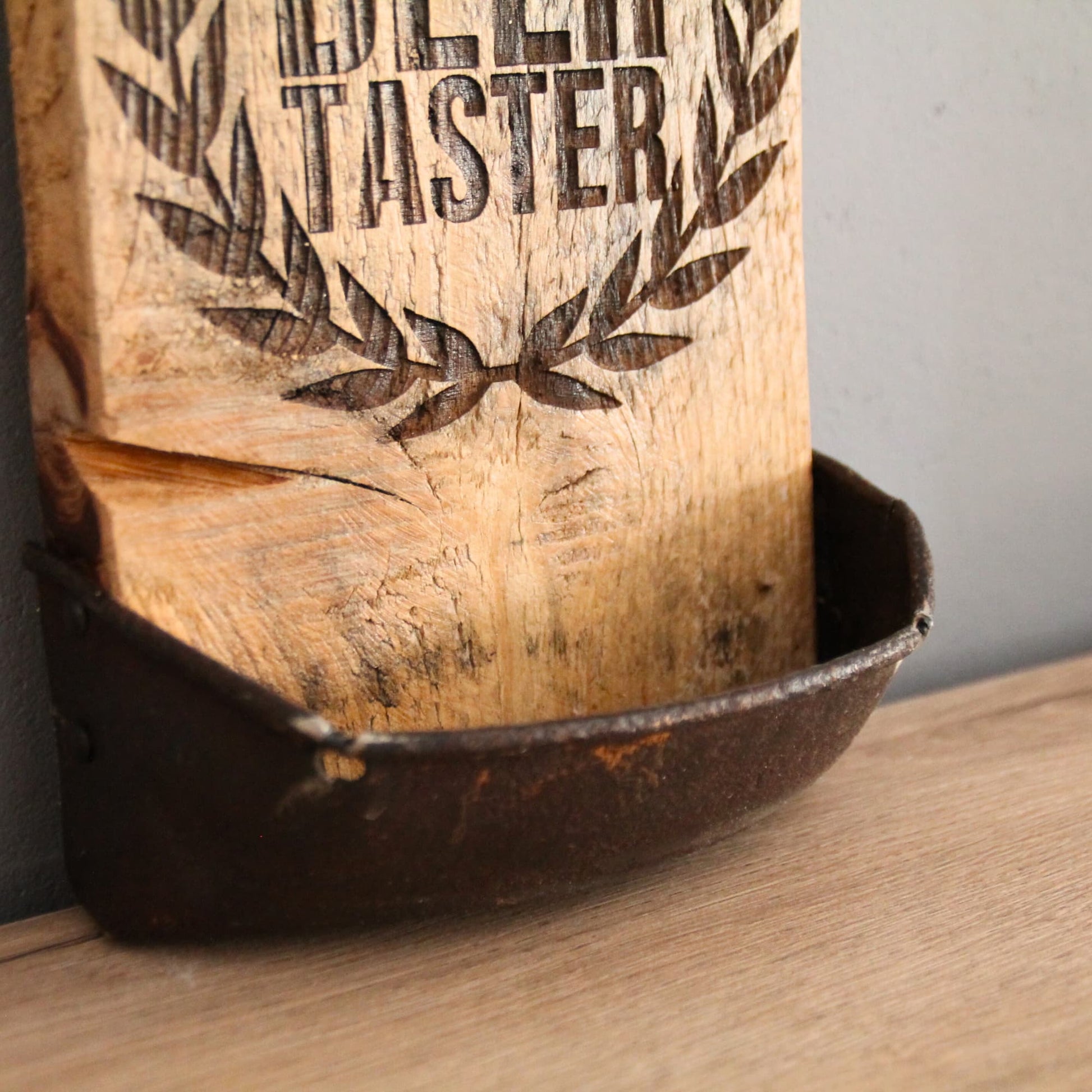 Zoom sur le bac de récupération de capsules en forme biseauté du décapsuleur en bois fait à la main et gravé "Professional Beer Tester".