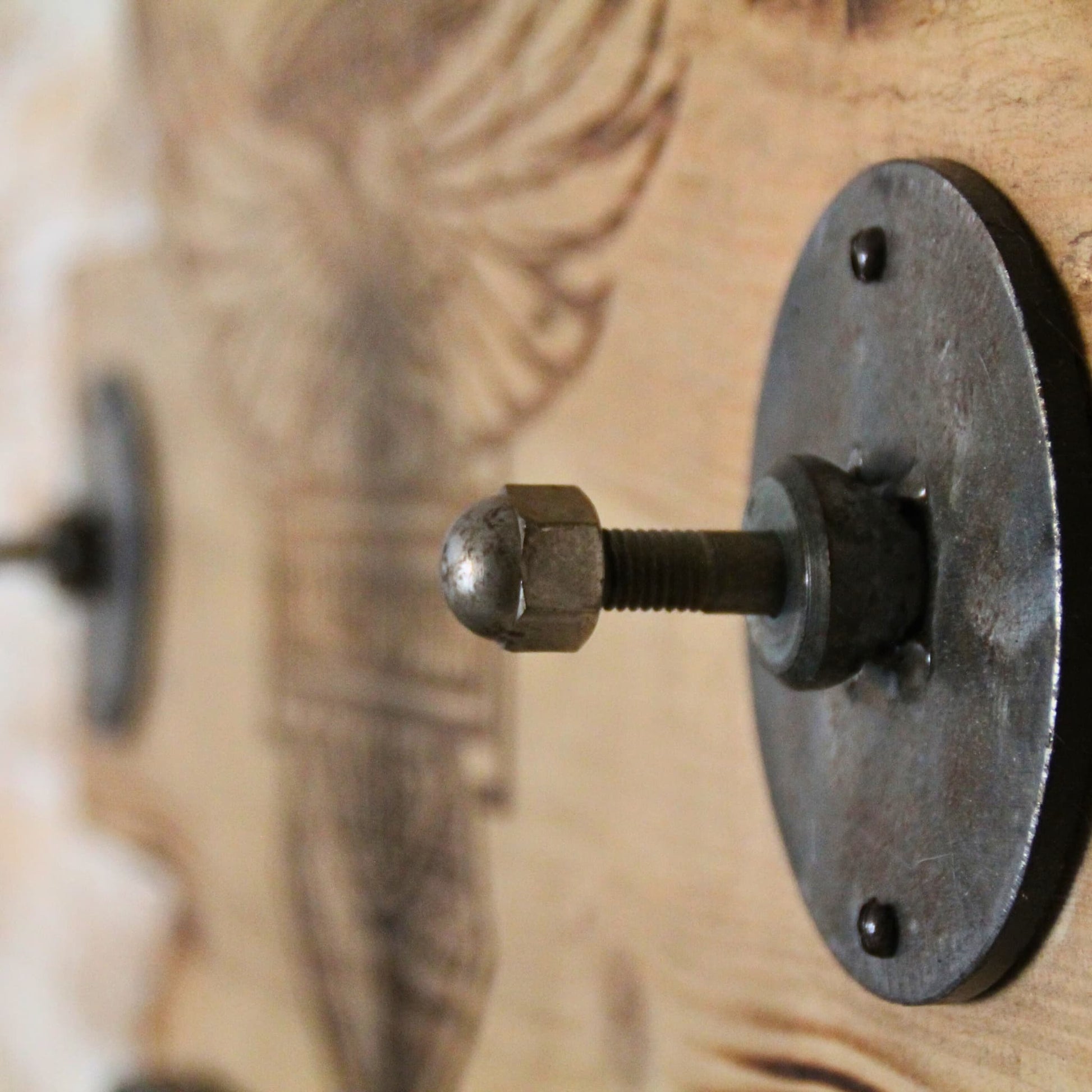 Zoom sur les détails en métal du support de casque en bois Harley Davidson.