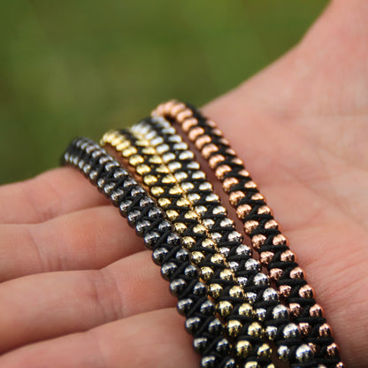 Bracelets ajustables marque Roadstrap double roulement à billes. Quatre couleurs au choix : noir, doré, rose gold, argent.