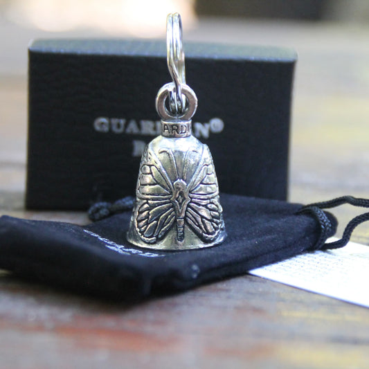 Clochette moto Guardian Bell papillon sur sa pochette en velours noire