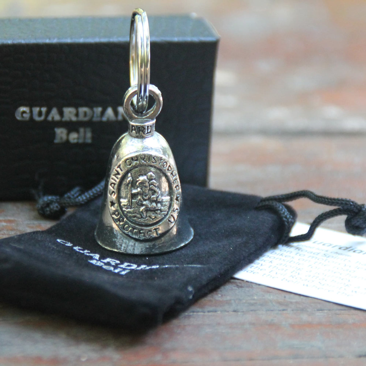 Guardian Bell Saint Christophe avec sa pochette officielle en velours noir et sa carte de la légende