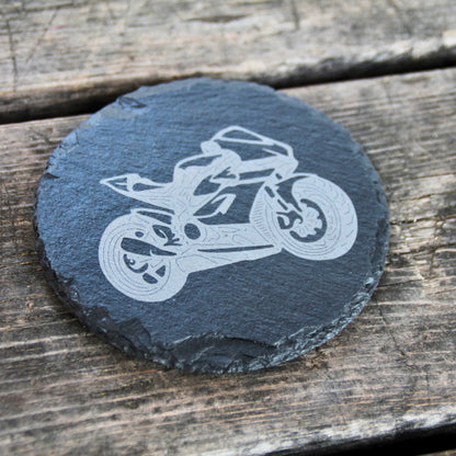 Dessous de verre rond en ardoise naturelle gravé d'une moto sportive. 