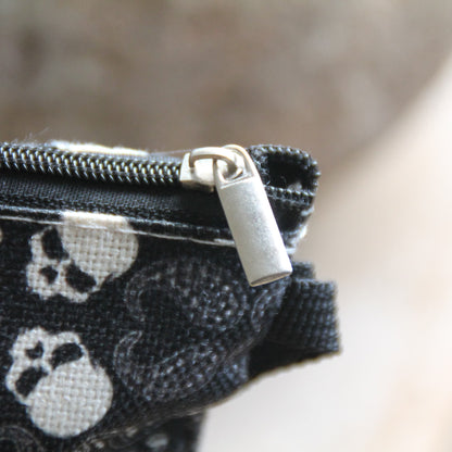 Gros plan sur la fermeture éclair de la pochette motarde tête de mort bandana